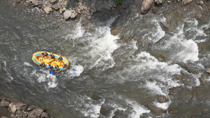 Topview of people in a boat. Seething flows of river water.