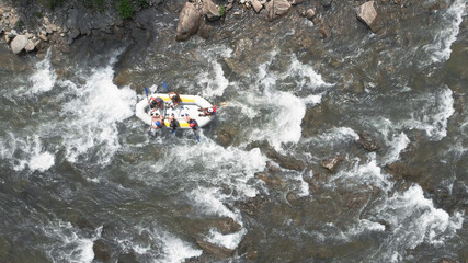 People float down the river. Raffers in a rafting boat.