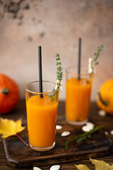 freshly squeezed pumpkin juice with thyme in tall glasses