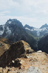 sunny road in the mountains. stone and grassy landscape