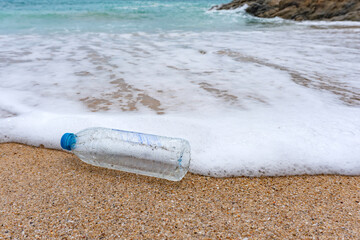 Plastic bottle waste is an environmental pollution on the beach