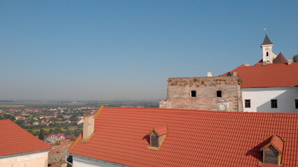 Top of medieval fortress. Ancient tower as historical heritage. City landscape on the background.