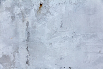 Concrete wall with long, winding, thin cracks. Studio background for decoration and design