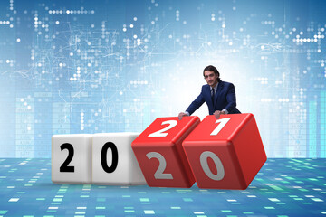 Businessman turning the year from 2020 to 2021