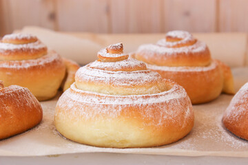 Soft, fluffy buns sprinkled with powdered sugar