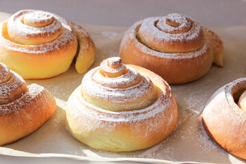 Soft, fluffy buns sprinkled with powdered sugar