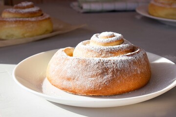 Soft, fluffy buns sprinkled with powdered sugar