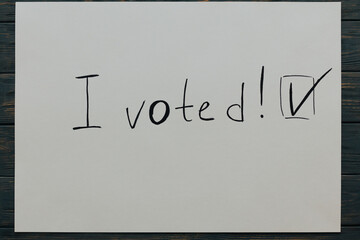 I voted. Political slogan on white paper. Top view