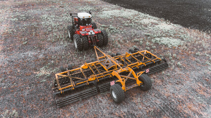 tractor in the field with a disc harrow