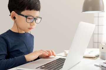 Physical distancing, New normal, Education Technology concept. A smart asian boy stay home and...