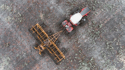 tractor in the field with a disc harrow