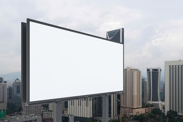 Blank white road billboard with KL cityscape background at day time. Street advertising poster, mock up, 3D rendering. Side view. The concept of marketing communication to promote or sell idea.