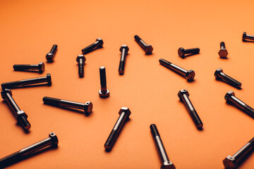 Bolts closeup on orange background.