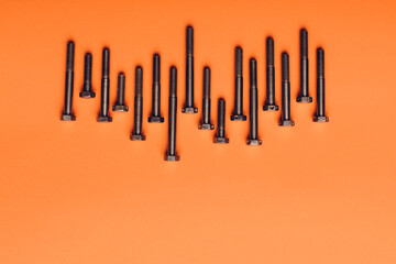 Bolts closeup on orange background.