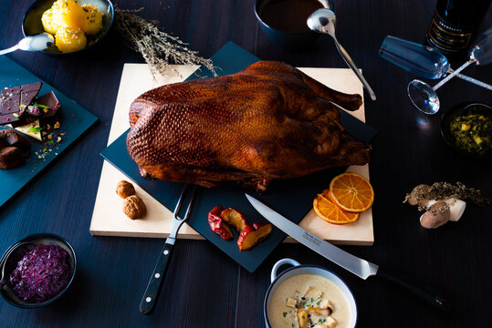 Martinsgans braten mit Garnituren und Beilagen aus der Vogelperspektive. 
