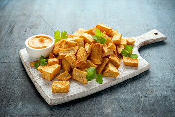 Patatas bravas traditional Spanish potatoes snack tapas on white wooden board