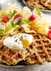 Vegetarian food of vegetable waffles with green salad, tomatoes on a plate