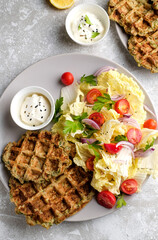 Vegetarian food of vegetable waffles with green salad, tomatoes on a plate