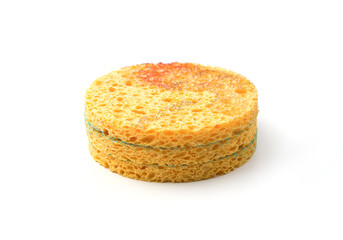 Three face cleaning sponges stacked on top of each other and isolated on a white background, side view. Beauty, skin care. The concept of facial skin cleansing.