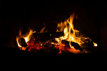 Fireplace fire with flames and black background