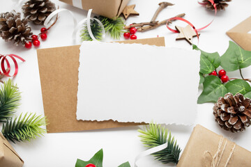 Top view of Christmas composition with gift box, ribbon, fir branches, cones, anise on white background with copy space.