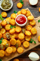 Mini hash browns, tater tots crispy golden potato bites served with jalapeno peppers dipped in ketchup