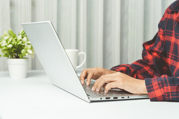 Fototapeta premium Close up. Hands typing keyboard on white laptop in office.
