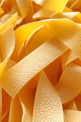 Raw pappardelle pasta macro background -  Italian food ingredient