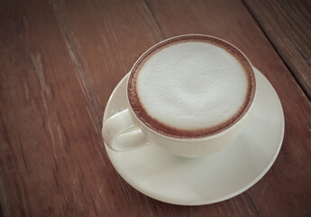 Cappuccino coffee cup on the wooden table