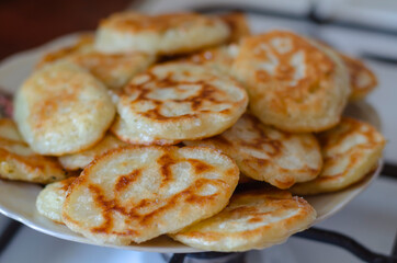 A serving of fried pancakes on a plate.