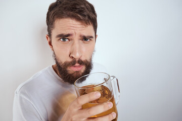 emotional man with a large mug of beer alcoholic drink gesturing with his hands drunken state