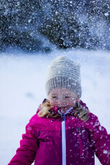 little girl playing with snow