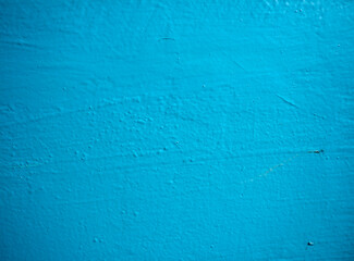 Entrance wall in blue paint. Texture of blue paint on cement and plaster