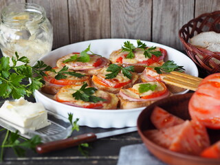 Healthy breakfast with hot sandwiches with cheese and tomatoes and a cup of coffee on a wooden ancient background with ingredients for their preparation.Homemade natural food.