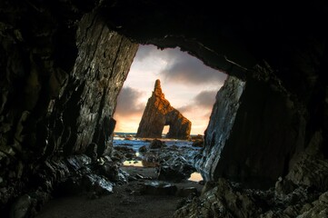 Sunrise from inside the cave of Campiecho in Asturias, Spain.