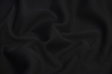 Smooth elegant black silk or satin texture can use as abstract background. Luxurious background...