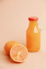 Fresh orange juice bottle and fresh orange slice.