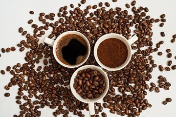 Three  cups of  coffe with naturel coffe beans as background.