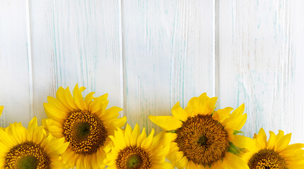 Postcard with flowers of a sunflower on a light wooden background. Frame for text for Thanksgiving,...