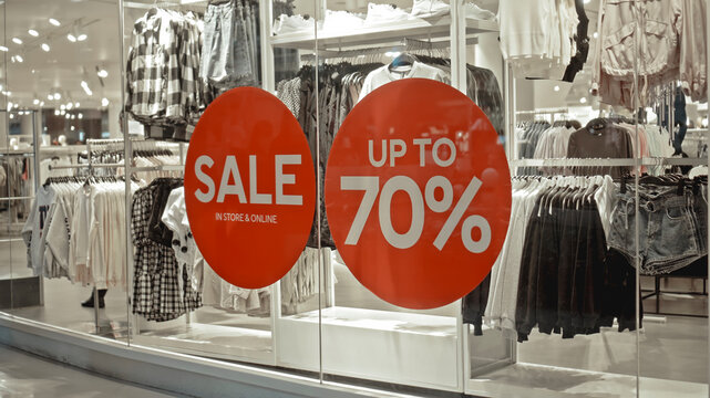 text on the red sticker on the glass in the store with the inscription sale up to 70% off