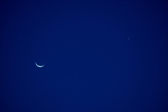 Crescent moon in sky.