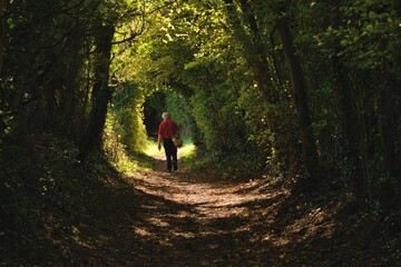 elderly photographer walking into the light