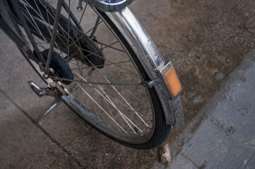 The wheel and mudguard of a vintage bike.