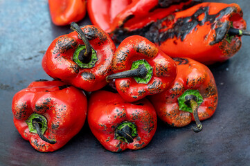 Fresh red peppers being grilled on hot plate for preparation of traditional Balkan's spread ajvar