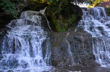 Scenic view of cascading 16 meters Dzhurinsky waterfall on the river Dzhurin. It is the largest in Ukraine plain waterfall. Nyrkiv, Ternopil region, Ukraine