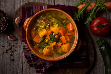 Vegetable soup with parsley on dark background