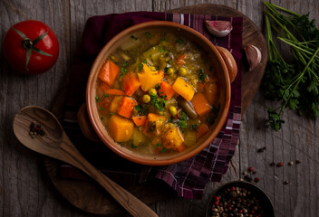 Vegetable soup with parsley on dark background