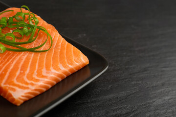 Slices of Raw Salmon Fillet on Black Background