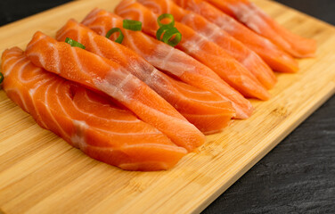 Slices of Raw Salmon Fillet on Black Background