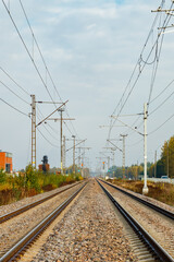 Fototapeta premium Two lane railroad with electric power lines